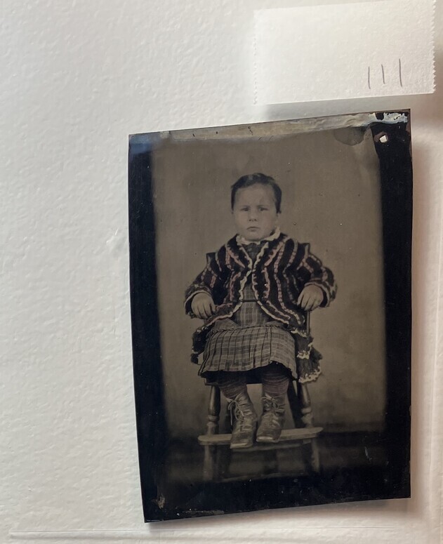 Untitled (Portrait of a Seated Young Child Wearing Laced Boots and a Striped Coat)