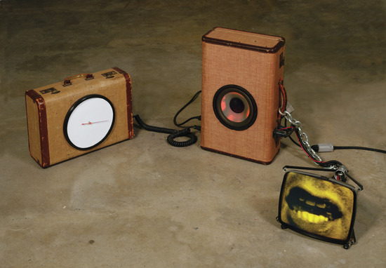 Sculpture 1 of 3 titled Train of Thought, Suitcase, clock, chain, fluorescent lamp, electronics, speaker, accession number 1996.35.a-c.