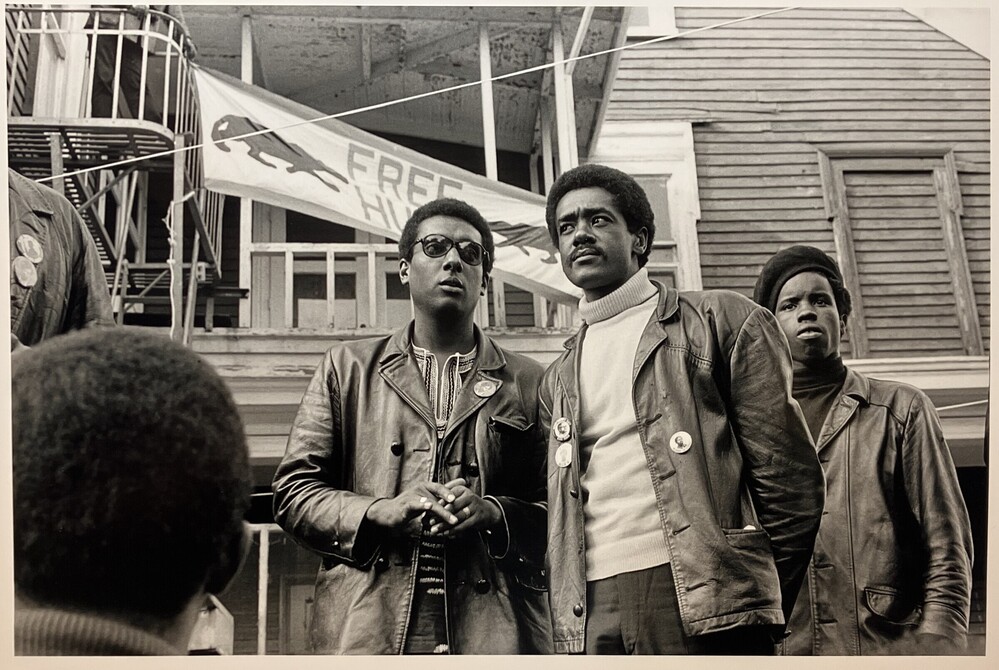 Photograph titled Bobby Seale, Chairman of the Black Panther Party and Stokely Carmichael, ex Prime Minister at Free Huey Rally, Bobby Hutton Memorial Park, Oakland, CA, number 64 from the series A Photo Essay on the Black Panthers, Gelatin silver print, accession number 2012.35.25.
