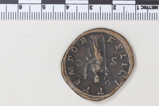Hearst Museum object 5 of 8 titled Coin: æ sestertius, accession number 8-5921, described as Coin: Sestertius; Æ; Gordianus.Pius - 17.17 grams. Rome, 240-244 AD. Obverse: IMP GORDIANVS PIVS FEL AVG - bust facing right, laureate, draped, cuirassed. Reverse: FELICI T TEMPOR, SC - Felicitas standing holding long caduceus and cornucopiae.