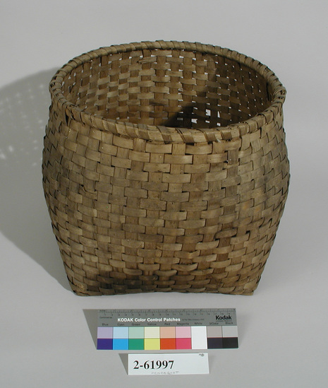 Hearst Museum object titled Basket, accession number 2-61997, described as Round basket with square base. Made of brown ash; checker plaited. Damage: hole in one corner.