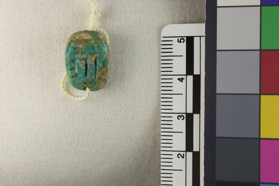 Hearst Museum object 18 of 19 titled Amulet, accession number 6-8801, described as Oval plate amulet, blue glaze partly gone