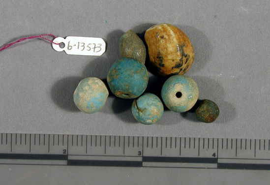 Hearst Museum object 1 of 4 titled Beads, accession number 6-13573, described as Beads: 3 blue spherical, 1 blue barrel shaped, 1 shell.  [inv.: 7 ball beads (faience), 1 shell bead, original object count: 5?]