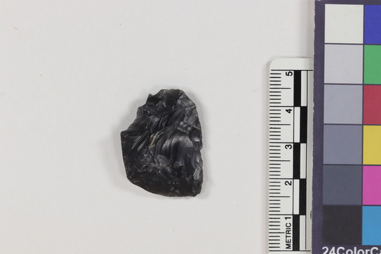 Hearst Museum object titled Flake, accession number 16-14432, described as Flaked obsidian. Projectile point fragment; obsidian; triangular; weight: 3.65 grams; length: 2.3 cm; width: 3.0 cm; depth: 0.5 cm.