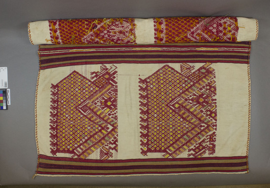 Hearst Museum object 3 of 3 titled Tzute, accession number 3-35, described as Woman’s shawl and headdress (Xute); 3-35 wool and cotton; brocaded; multicolored with white background; approximately 88 cm x 77 cm; 3-36 white wool brocaded with red and yellow cotton with tassels on the corners; approximately 60 cm x 60 cm Remarks: "The Xute is used by both men and women, wrapped around the head;  when large enough, around the shoulders"