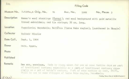 Documentation associated with Hearst Museum object titled Stocking, accession number 7-5185a,b, described as Woman's wool stockings (čorapi); red wool background with gold metallic thread embroidery; red tie strings; 35 cm long