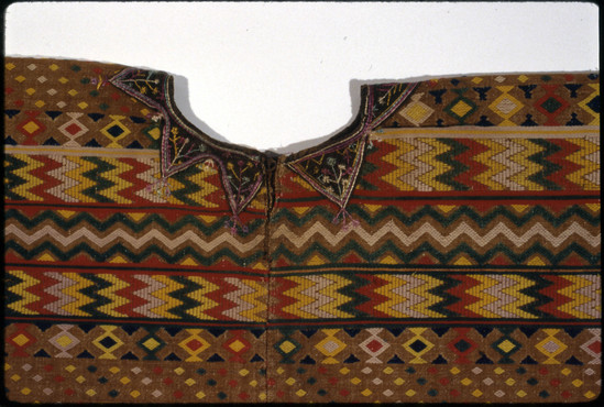 Hearst Museum object 3 of 4 titled Huipil, accession number 3-37, described as Woman’s garment (huipil); white cotton, plain weave; upper part brown cotton, plain and twill weaves with multicolored brocade in cotton and silk; neck bound with fabric and embroidered; approximately 93 cm wide, 1 m long