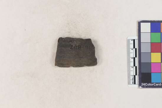 Hearst Museum object 2 of 2 titled Potsherd, accession number 16-8117, described as Potsherd: rim with deep incisions or notches forming design. Section of Manta on Beach currently inhabited. Numbers  8111 to 8194 are sherds picked up on beach at low tide.