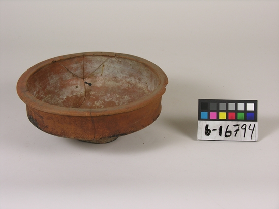 Hearst Museum object titled Bowl, accession number 6-16794, described as pottery: smooth, red bowl; incised lines, straight rim with flanged lip, pedestal, diameter 20, height 7 cm