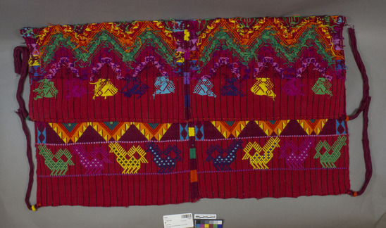 Hearst Museum object titled Head cloth, accession number 3-29231, described as Textile/ utility cloth/ tzute; cotton with varicolored zigzag bands with row of birds at top, row of four legged animals below; red warp face with black stripes; two loom widths sewn together; maroon cotton corner tassels; 74 X 82.5 cm. Shawl/ head covering/ carrying cloth. Design said to be "feathered serpent effect." This example is a "male tzute." Made in 1980's. Per Ann Rowe to wear the tzute, it is folded in half diagonally, with the fold low over the forehead. The two ends at the extremities of the fold are tied over the ends that hang down in back. The tassels often hang down in back; sometimes those from the tied corners hang down in front. Often the tzute is worn with the wrong side of the weaving facing out, presumably to protect the right side. For certain religious functions, the tzute is removed from the head and draped over the shoulders. Textile analysis form in accession envelope.