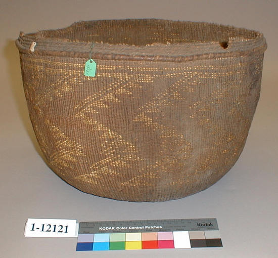 Hearst Museum object titled Soup bowl, accession number 1-12121, described as Very old large cylindrical cooking basket with hoop at border.  Grimy and worn from use.  Hole in bottom.  2-faced overlay; vertically zig-zagging bands of triangles, 2 stripes around top.  3-strand twining 4.5 radius from start, then 2 rows at 7 cm radius from start, and 4 top rows around rim; fifth row from the top peeled shoots lattice woven into place.  Tag: "Wailaki". Per Ralph Shanks:  Twined cooking basket, used.  Crossed warp start, not a traditional wrapped Northwest California style starting knot, it has several plain twined rows on the exterior and interior, probably over four warps.  See 1-2543 and 1-97844 for a similar start.  The warp material is a peeled shoot, possibly willow; the wefts are conifer root with an overlay design in beargrass.  The rim is trimmed with a few warp sticks protruding at the non broken areas of the rim.  The basket somewhat undulates.  The work direction is to the right, with an exterior workface and up to the right slant of weft twist.  The overlay is irregularly double-sided, with the main design on the exterior.