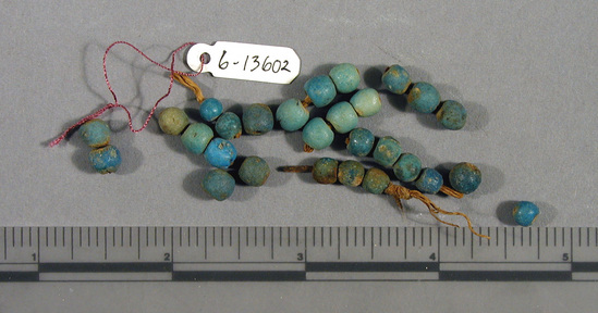 Hearst Museum object titled Beads, accession number 6-13602, described as Beads: blue glaze spherical on 8 fragments of original string.