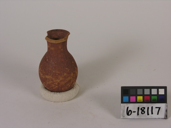 Hearst Museum object titled Broken bottle, accession number 6-18117, described as Pottery: maroon bottle, long neck, rim broken; least diameter 5 cm, greatest diameter 7 cm, height 12 cm.