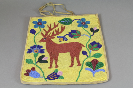 Hearst Museum object 3 of 3 titled Bag, accession number 2-37065, described as Made of beaded deerskin; yellow glass "seed" bead ground; brown deer motif with surrounding floral design. Thong handles.