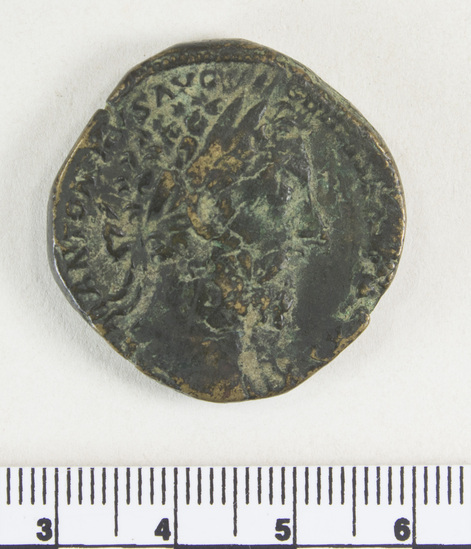 Hearst Museum object 5 of 7 titled Coin: æ sestertius, accession number 8-6228, described as Coin: Sestertius; Æ; Marcus. Aurelius - 25.12 grms. Obverse: M ANTONINVS AVG     GERM[SARM TRP] XXXI - Head facing right, laureate. Reverse: [IMP VIII COSIII PP] [SC] - Pile of arms; beneath: DE GERMANIS.