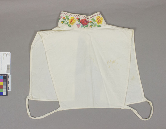 Hearst Museum object 3 of 3 titled Dickey, accession number 2-71667, described as Woman’s dickey. Ties at lower edge holding fronts to back. 30 cm. wide x 28.5 cm. long. 5 cm. high-standing collar.