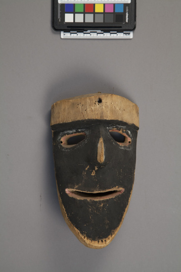 Hearst Museum object titled Mask, accession number 11-42717, described as Mask, pith wood, black face with remnants of white paint around eyes, red paint around eyes and mouth. 21.0 cm. Used in ceremonial dance.