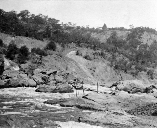 Hearst Museum object titled Photographic print, accession number 13-137, described as Karok man fishing at Amaikiara Village.