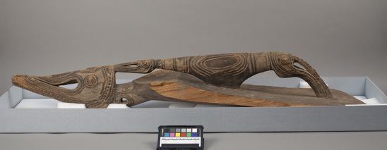 Hearst Museum object titled Canoe prow, accession number 11-37671, described as Canoe prow, carved wood, from a river canoe; stylized head of a crocodile and totemic birds; 111.8 cm. 1.