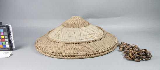 Hearst Museum object titled Hat, accession number 10-1959, described as Basketry hat with chain of rings, round, 2 bands of twined basketry, 1 of stitched palm leaves; palm leaf lining, no headring, 16¼ inches diameter