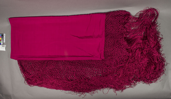 Hearst Museum object titled Shawl, accession number 7-10165, described as square, fuschia silk (undecorated) shawl, with deep hand knotted (netting design) fringes on all 4 sides.  c. 1925