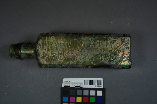 Hearst Museum object titled Bottle, accession number 1-160936, described as four sided green glass shouldered bitters bottle, with applied hand finished lip, embossed label on three sides "...UDOLPHO WOLFE'S" "AEROMATIC SCHNAPPS" "SCHIEDAM", no makers mark on the bottom