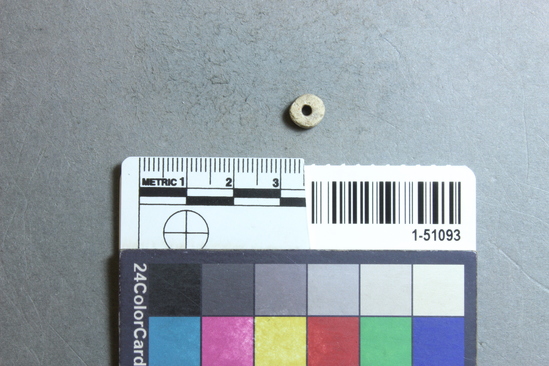 Hearst Museum object titled Bead, accession number 1-51093, described as steatite disc bead, 7mm dia.