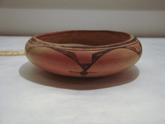 Hearst Museum object 3 of 3 titled Bowl, accession number 2-30129a,b, described as Bowls; pottery. a) Polychrome B and R/orange. Wide mouth, shallow jar.  Incurved rim; roughly seed-bowl type shape. Interior plain; exterior red rim band. Broad and narrow framing lines below rim; no lower framing lines. Continuous scalloped line around shoulders, pendant to framing line; corner blocked triangles, pendant dot and crossed on parallel lines; six points.  b) Oval bowl; shallow; flat bottom and convex sides; rim slightly incurving. Polychrome B and R/orange... (continued in Comments)