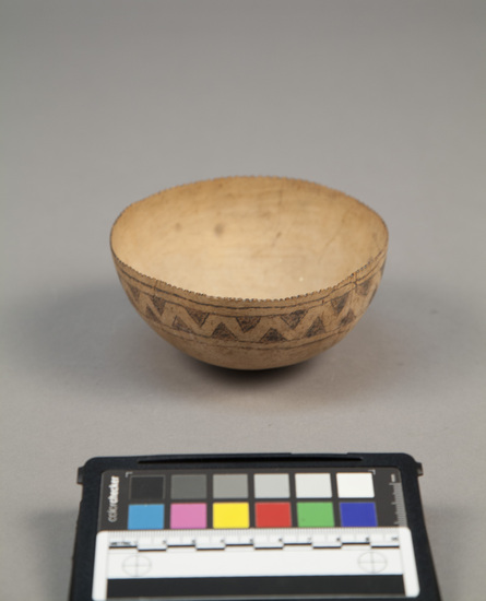 Hearst Museum object titled Coconut shell bowl w/ incised designs, accession number 11-43141, described as Bowl. Coconut shell with incised geometric design around edge, edge notched. diam. - 12.0 cm.