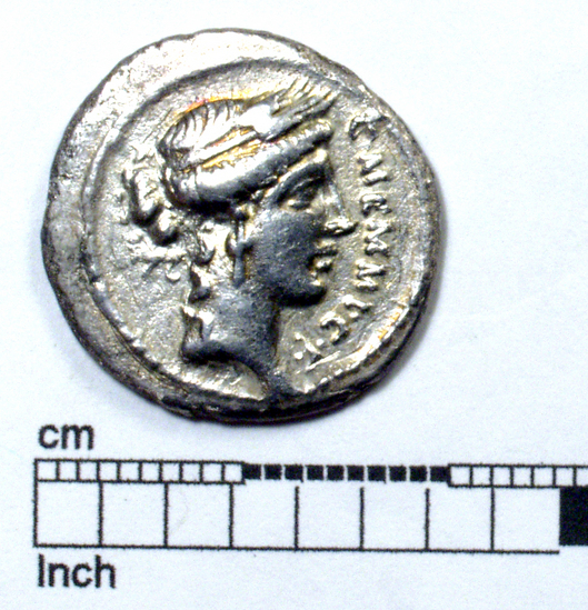 Hearst Museum object titled Coin: ar denarius, accession number 8-5814, described as AR Denarius. 3.27 grams.         plated coin? (C.Memmius C.F.) Obverse: Head of Cere r. crowned with corn ears, wears ring cruciform earring, hair in knot down neck. On r. C.MEMMI C.F. Reverse: Naked prisoner of war kneeling before trophy ornamented with Greek or oriental shield. On l., (C.MEMMIVS) IMPERA (TOR)