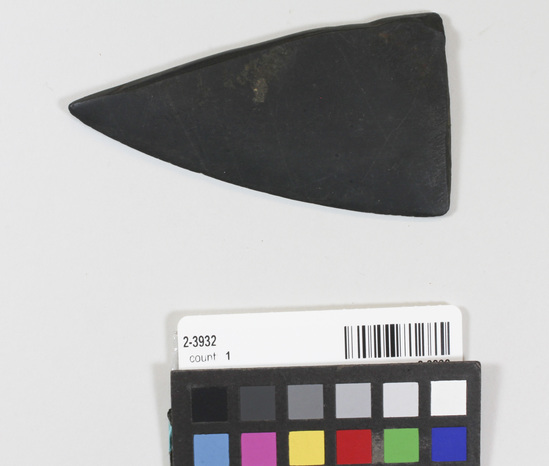 Hearst Museum object titled Knife, accession number 2-3932, described as Head of whaling knife (?), probably  partial ulu blade. Triangular fragment with cutting edge sharpened from both edges.