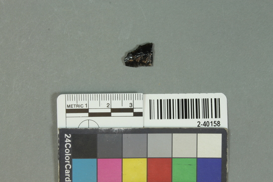 Hearst Museum object titled Biface fragment, accession number 2-40158, described as Obsidian biface point tip.