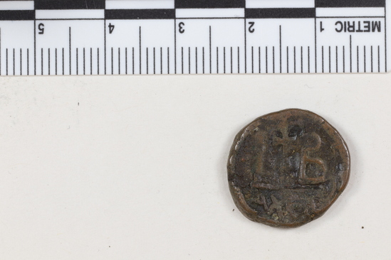 Hearst Museum object titled Coin: æ 10 nummia (decanummium), accession number 6-23175, described as Obverse: two frontal busts of soldiers, each wearing a cross on their helmets, separated by a cross. Reverse: an I surmounted by a cross flanked by Left: [symbol resembling open parenthesis]; Right: [symbol resembling capital beta] below in ex. [three symbols, the second resembling lambda and the third resembling epsilon] Denomination: decanummium Size: 1.8 cm Weight: 4.86 g Condition: fair Content: AE  Provenience: Naga-ed-Der, Egypt. Hoard of 68 coins (6-23121-88) Mint Date: Alexandria Heraclitus 610-14 A.D. Reference: Warwick Wroth. Byzantine Coins.