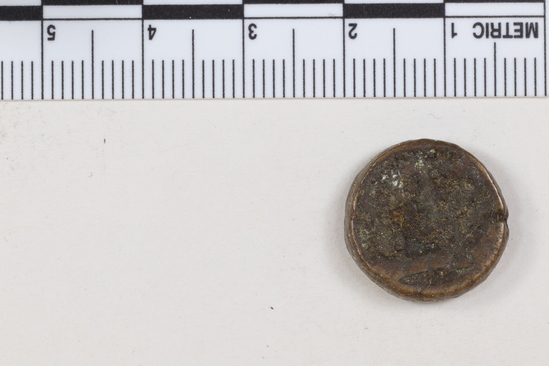 Hearst Museum object titled Coin: æ 12 nummia (dodecanummium), accession number 6-23182, described as Obverse: two frontal busts of soldiers, each wearing a cross on his helmet, separated by a cross. Reverse: an I surmounted by a cross flanked by Left: [symbol resembling an open parenthesis]; Right: [symbol resembling an uppercase beta] below in ex. [three symbols, the first resembling lowercase lambda, the second resembling epsilon, the third resembling lowercase xi] Denomination: 12 nummi Size: 1.65 cm Weight: 6.65 g Condition: fair Content: AE Provenience: Naga-ed-Der, Egypt. Hoard of 68 coins (6-23121-88) Mint Date: Alexandria Heraclitus 610-14 A.D. Reference: Warwick Wroth. Byzantine Coins.