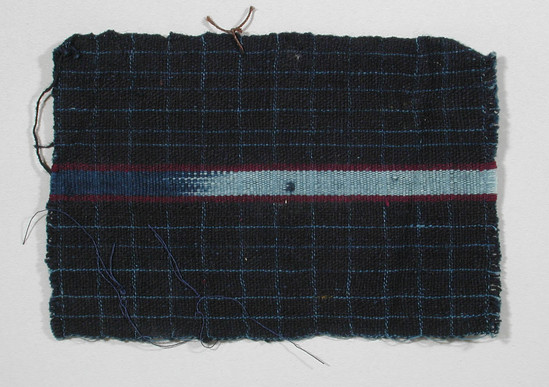 Hearst Museum object titled Textile fragment, accession number 5-11329, described as textile sample (section of narrow band weaving): indigo with light blue pin stripes, center ikat: light blue and royal blue flanked by maroon.