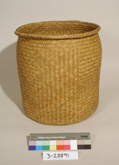 Hearst Museum object titled Basket, accession number 3-28891, described as Basket. Large, round, open flexible "tote" basket, woven palm. L 35.5 cm, diameter 33cm.