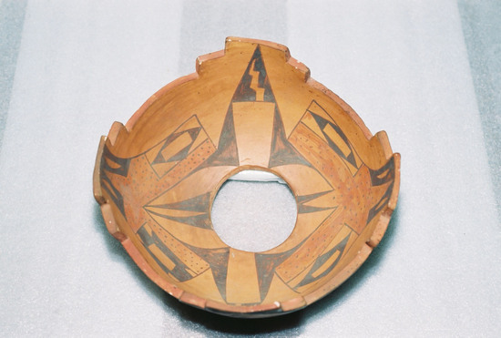 Hearst Museum object 3 of 7 titled Bowl, accession number 2-18708, described as Ceramic, terraced rim, round hole in base, geometric design on interior, stylized bird and floral design on exterior in brown and red on buff/orange ground. Molded and painted.