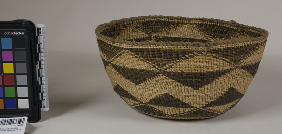 Hearst Museum object 2 of 2 titled Basket, accession number 1-14237, described as Food basket; twined. Warp is twisted Tule (Schoenoplectus acutus) and Nettle (Urtica), weft is Tule string. White pattern is Reed (Phragmites vulgaris). Black color is mud-dyed split Tule.