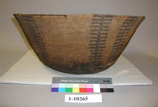 Hearst Museum object titled Basket, accession number 1-10265, described as 3-Rod coiled with interlocking stitches, with flaring sides. Decoration: vertical banding, in black. Broken at several places along the rim as well as near the bottom.