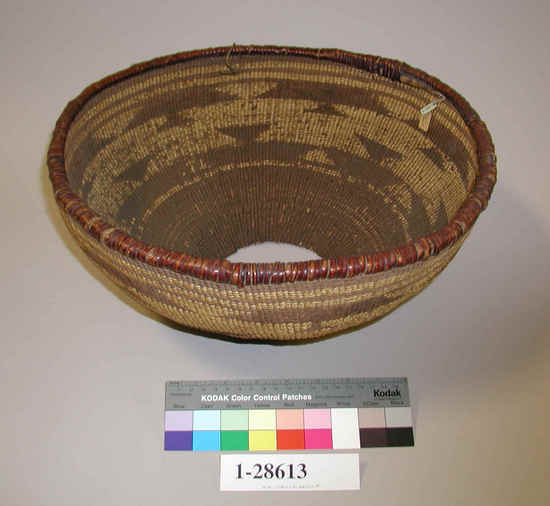 Hearst Museum object titled Basket, accession number 1-28613, described as Basketry hopper. Per Ralph Shanks:  Mortar hopper basket, used.  Materials are shoot warps, conifer root wefts with beargrass overlay, the rim is redbud wrapped.  Designs are formed by the contrast of the beargrass overlay and the unwrapped conifer root wefts.  This is common in the Wintu area. Twining from the bottom: three strand interspersed by three rows of latice twining over reinforcing rods, the side is plain twined.  Wintu, Achumawi, or Atsugewi.