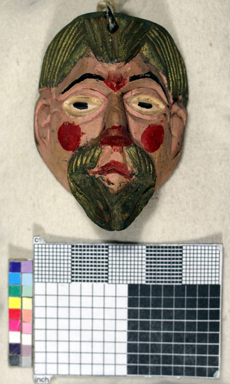 Hearst Museum object titled Toy mask, accession number 3-15592, described as Carved wooden toy mask; painted pink face