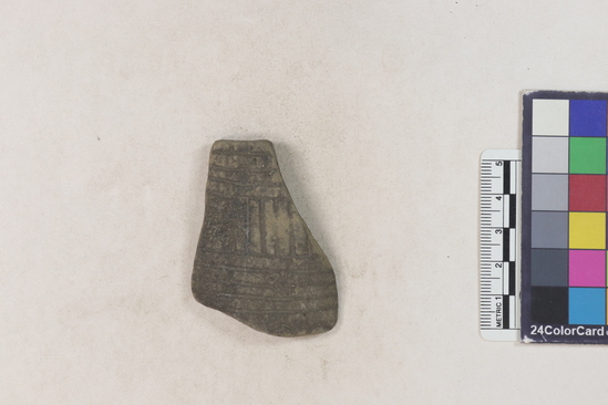 Hearst Museum object 2 of 2 titled Potsherd, accession number 16-8129, described as Potsherd; body or bottle neck incised desig. Section of Manta Beach currently inhabited. Numbers  8111 to 8194 are sherds picked up on beach at low tide.