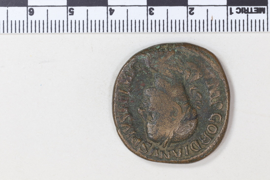 Hearst Museum object 8 of 8 titled Coin: æ sestertius, accession number 8-6128, described as Coin: Sestertius; Æ; Gordianus. Pius - 24.06 grams. Obverse: IMP GORDIANVS PIVS FEL AVG - Bust facing right laureate, draped. Reverse: LAETITIA AVG N, SC - Laetitia standing facing left holding wreath and anchor.