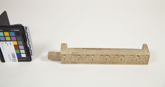 Hearst Museum object titled Stamp, accession number 9-23344, described as Spirit money stamp Light color on wood block with two faces on the edges. Engraved symbols of donkeys and men in a symmetric grid.