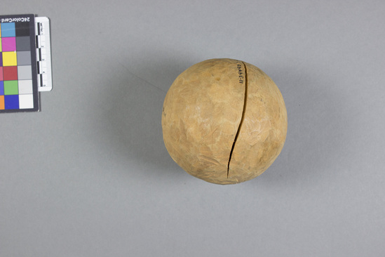 Hearst Museum object 1 of 2 titled Wooden sphere, accession number 11-39498, described as Ball; oval wood; split; for adult; used in game similar to bowling (ball tossed at a target; ball is to get as close to object as possible)