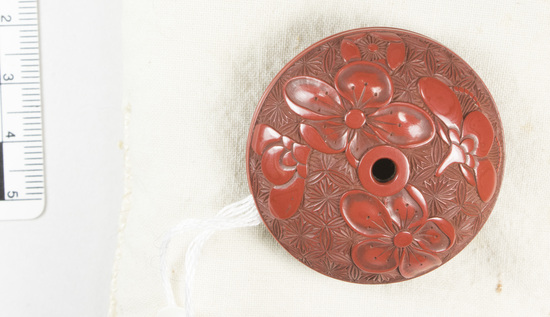 Hearst Museum object 1 of 6 titled Netsuke, accession number 9-18791, described as Netsuke; wood, two-piece, discoidal shape; floral design on both exteriors, halves nested together; metal ring inside center of one half, hole through center on other half; red; Manju style; Dia. 4.0 cm