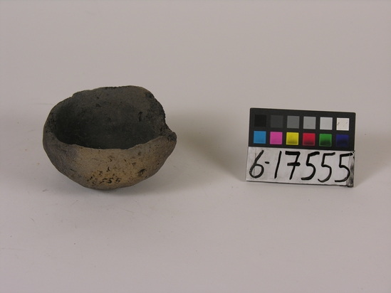 Hearst Museum object titled Broken dish, accession number 6-17555, described as Pottery: brown dish, blackened, rough, fragment missing; diameter 9cm., height 4.5cm.