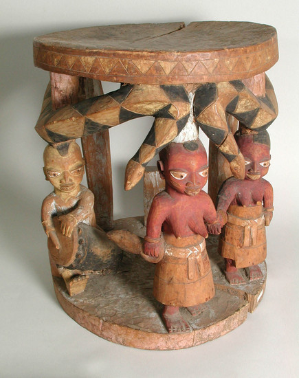 Hearst Museum object titled Stool (seating furniture), accession number 5-14085, described as Wood stool with three carved human figures with two snakes curving around upper edge, forming supports for top.  Carved in the solid.  Painted figures in naturalistic colors.  Height: 34 cm, Diameter: 29 cm