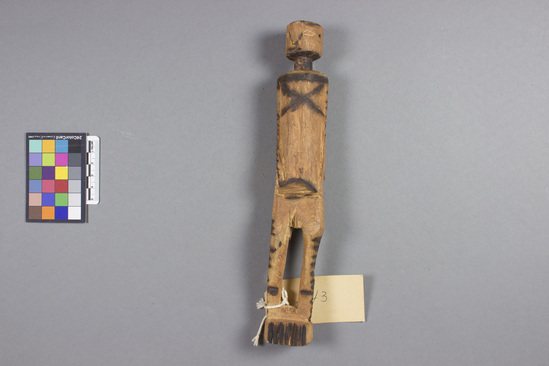 Hearst Museum object titled Doll, wooden, accession number 5-4423, described as Doll; carved natural wood with burned designs. Height 26 cm.