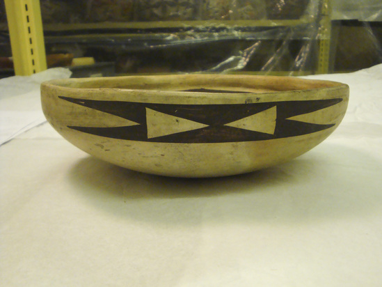 Hearst Museum object 3 of 3 titled Bowl, accession number 2-66100, described as Ceramic, cream colored with asymmetrical polychrome design on inside of bowl; broken in one area of rim, long crack on inner surface and 3 wear spots mar design.